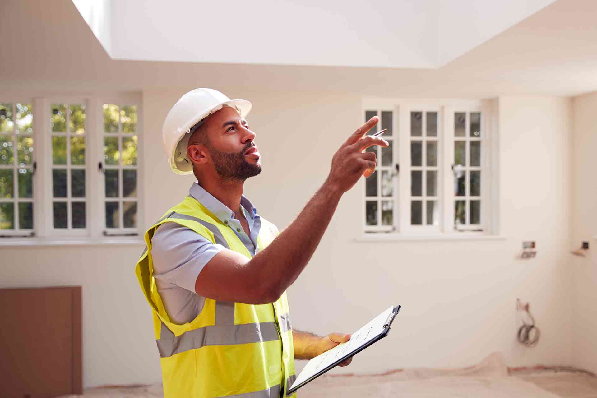 Third Party Wall Surveyors Exeter reviewing plans between two parties during a dispute